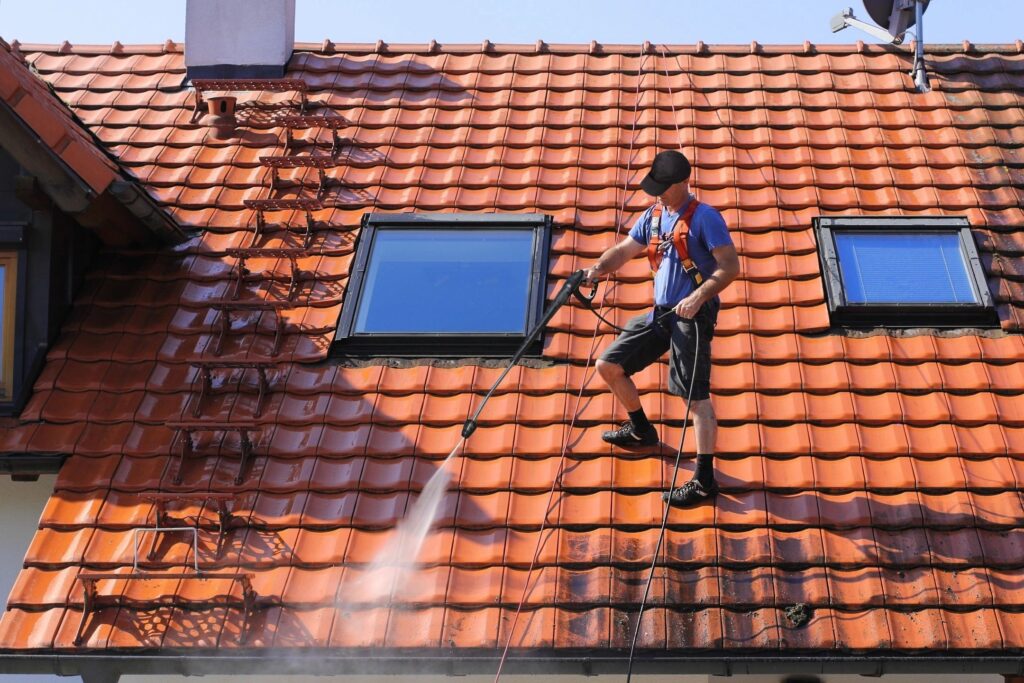 Professional roof cleaning by a roofing company in Los Angeles for roof repairs and installation services.